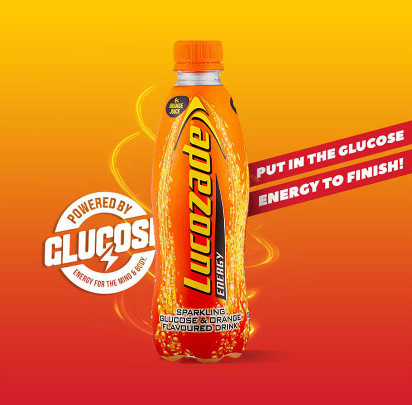 Current lucozade.co.za hero: orange-red gradient with old-pack bottle and Powered by Glucose roundel
